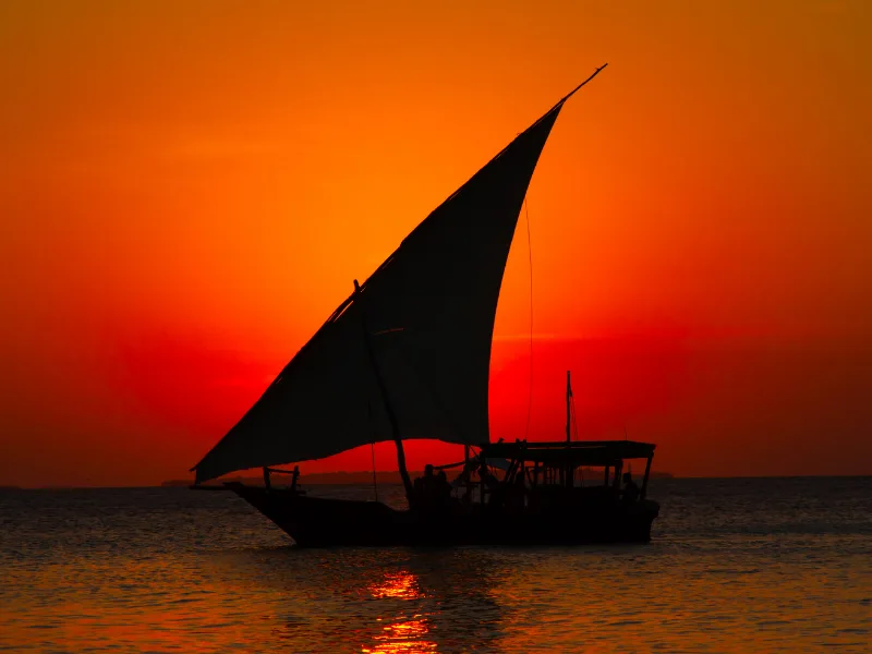 Traditional dhow boat at sunset in Zanzibar, holiday from Kenya